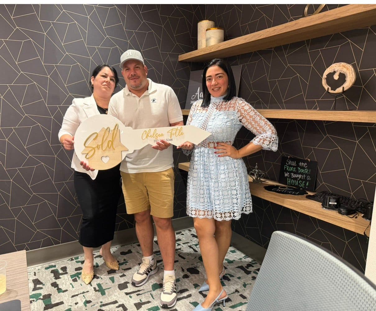 Lazara Diaz Tampa Bay Realtor toasting with clients in their brand-new kitchen on closing day